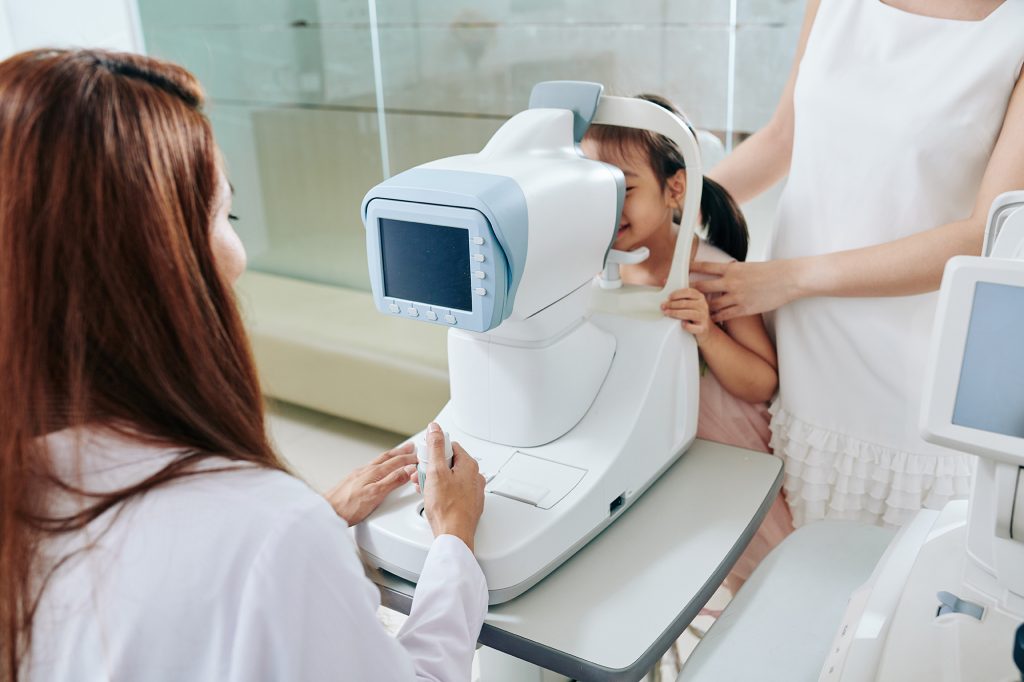 An Optometrist performing an eye test with a machine